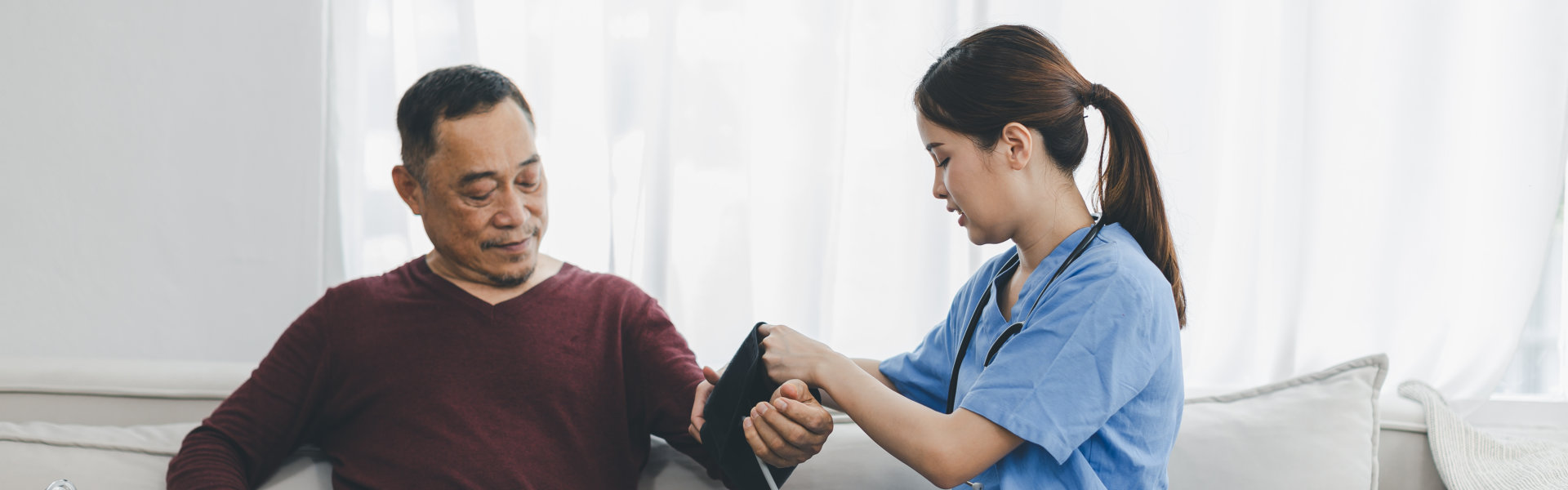 nurse checking blood pressure of the man